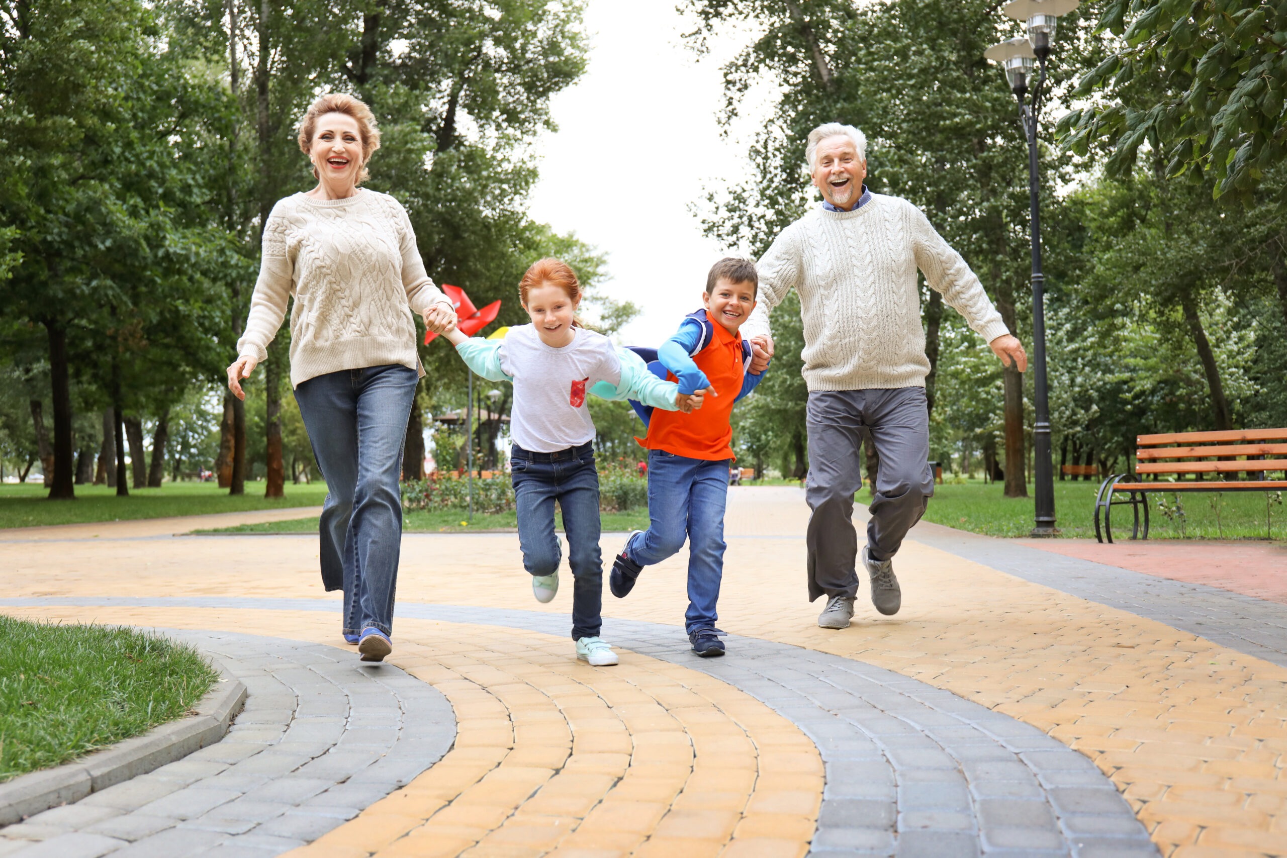 Little children with grandparents in park